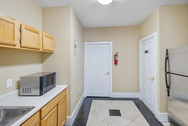 4000 Dancing Cloud Ct Unit 15, Destin, FL 32541 - interior space with a sink, light brown cabinets, baseboards, light countertops, and freestanding refrigerator