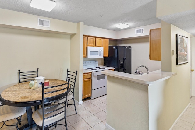 4000 Dancing Cloud Ct Unit 15, Destin, FL 32541 - kitchen featuring visible vents, light tile patterned floors, white appliances, and light countertops