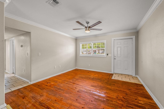 spare room featuring crown molding, ceiling fan, hardwood / wood-style floors, and baseboards