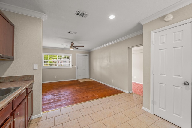 kitchen with ornamental molding, baseboards, a ceiling fan, light tile patterned floors, and recessed lighting