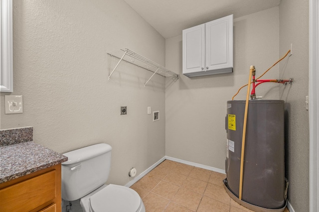 bathroom with water heater, vanity, baseboards, toilet, and tile patterned floors