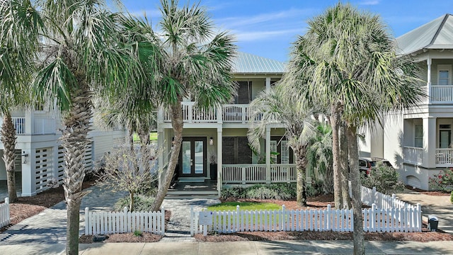 3592 Waverly Cir, Destin, FL 32541 - view of front of property with a porch, french doors, a balcony, and a fenced front yard