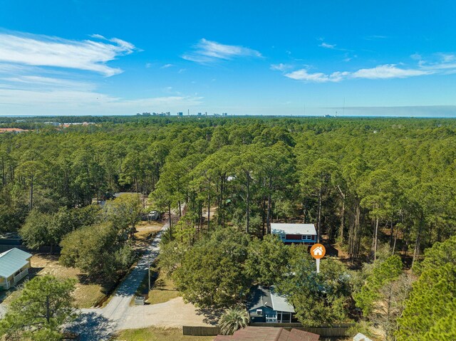 bird's eye view with a wooded view