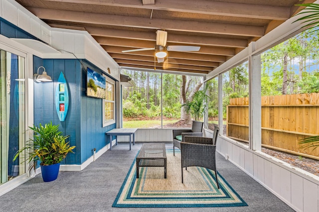 sunroom with outdoor lounge area, a ceiling fan, and beam ceiling