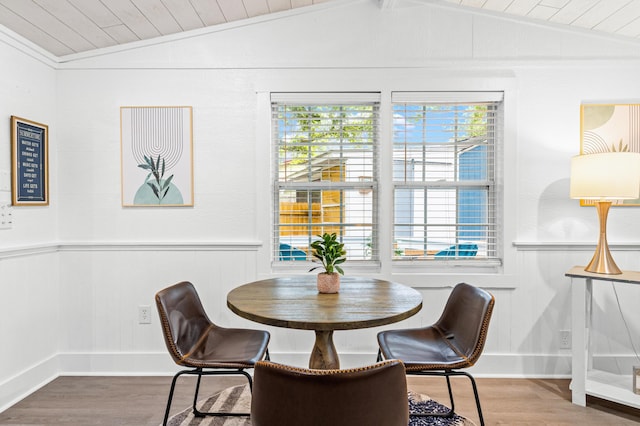 dining area with wainscoting, vaulted ceiling, baseboards, wood finished floors, and wood ceiling