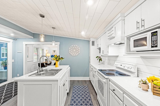 kitchen with a sink, a kitchen island with sink, white appliances, white cabinets, and dark wood-type flooring