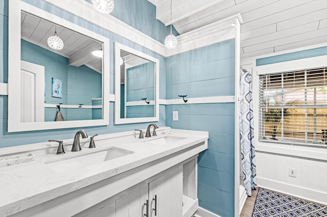 full bathroom with double vanity and a sink