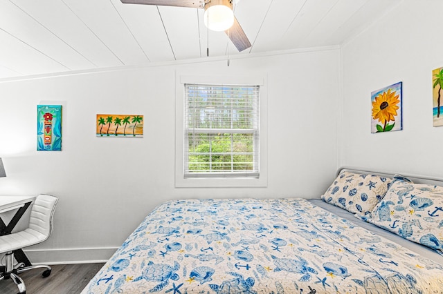 bedroom with wood finished floors, baseboards, and ceiling fan