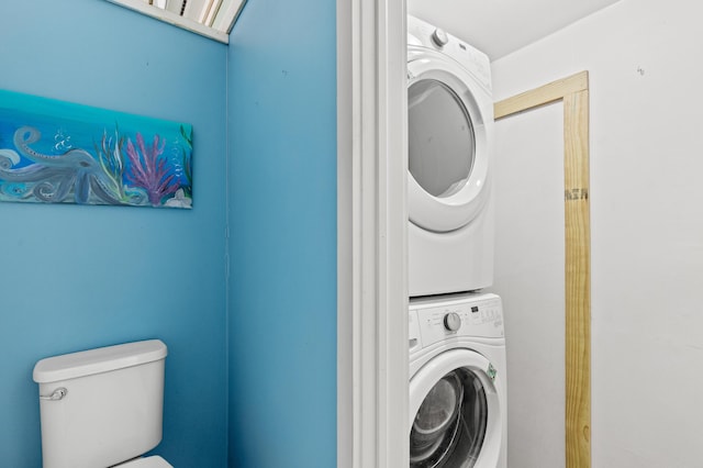 laundry room featuring stacked washer / dryer and laundry area
