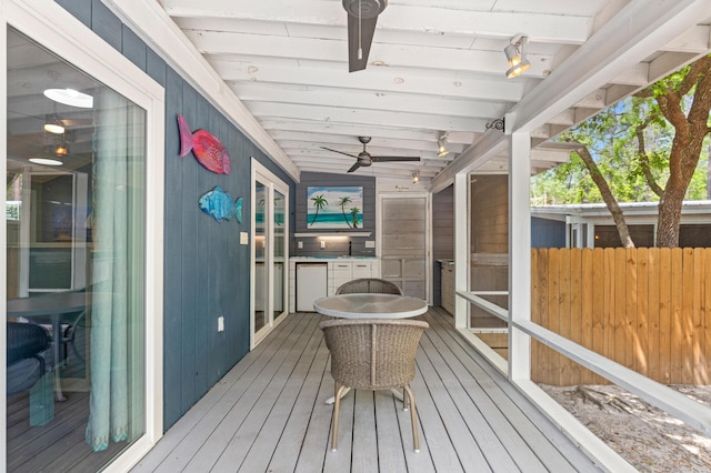 wooden deck featuring fence and a ceiling fan