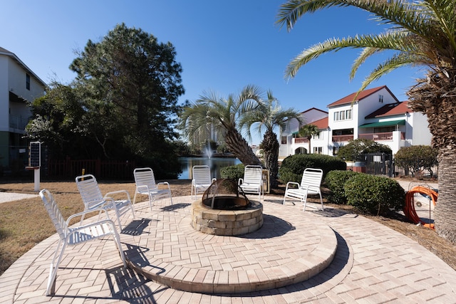 8730 Thomas Dr # 1210, Panama City Beach, FL 32408 - view of patio / terrace featuring fence and a fire pit