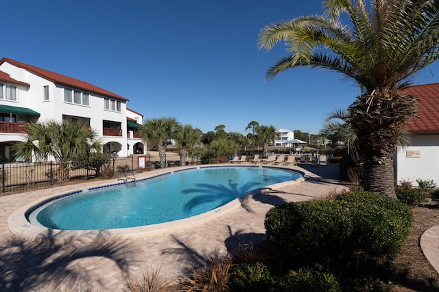 8730 Thomas Dr # 1210, Panama City Beach, FL 32408 - community pool featuring a patio and fence