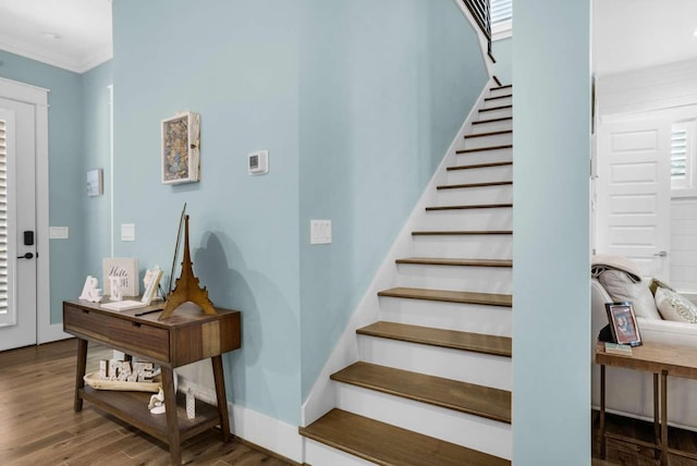 entrance foyer featuring stairway, wood finished floors, and crown molding