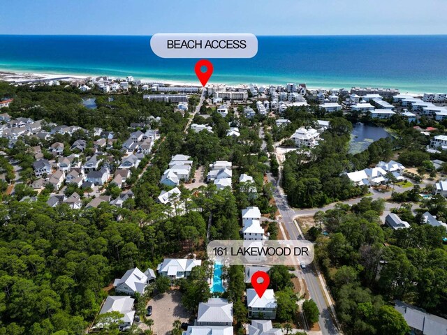 aerial view of property's location featuring extended coastline and nearby suburban area