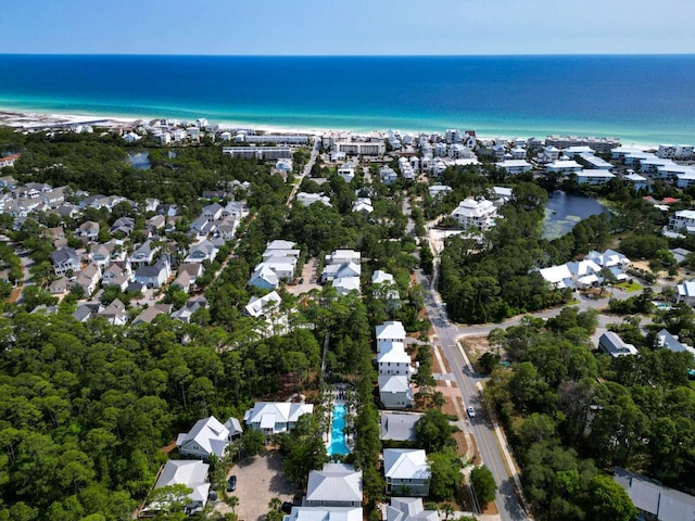 aerial view of property and surrounding area with a large body of water and nearby suburban area