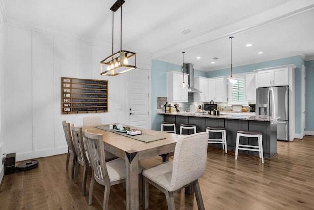161 Lakewood Dr, Santa Rosa Beach, FL 32459 - dining room with wood finished floors, a decorative wall, a chandelier, and recessed lighting