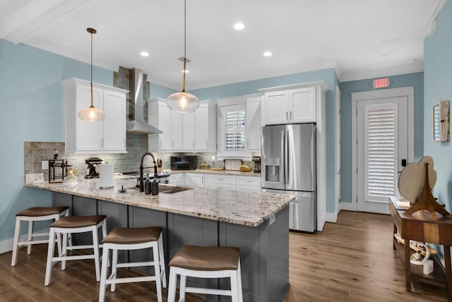 161 Lakewood Dr, Santa Rosa Beach, FL 32459 - kitchen featuring stainless steel refrigerator with ice dispenser, wall chimney exhaust hood, a peninsula, backsplash, and white cabinetry