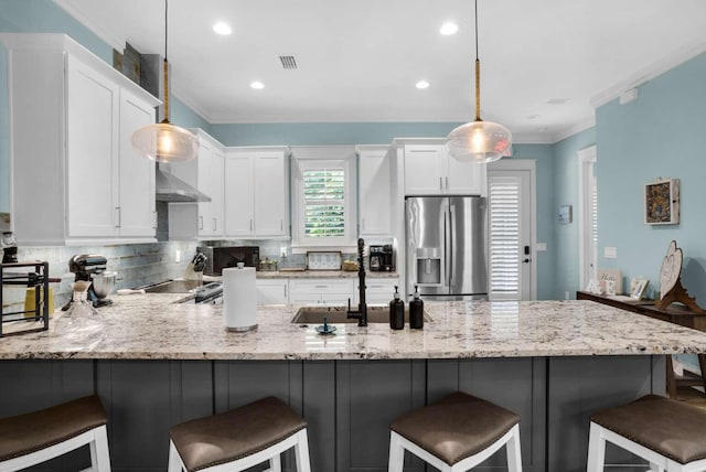 161 Lakewood Dr, Santa Rosa Beach, FL 32459 - kitchen with stainless steel fridge with ice dispenser, a sink, white cabinets, a peninsula, and crown molding