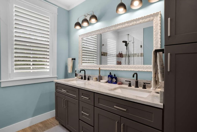 161 Lakewood Dr, Santa Rosa Beach, FL 32459 - full bathroom with a stall shower, wood finished floors, double vanity, and baseboards