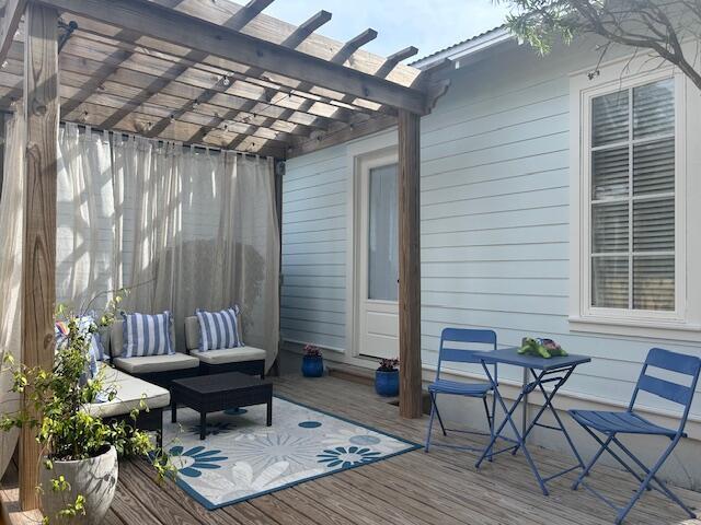 384 Carson Oaks Ln, Santa Rosa Beach, FL 32459 - wooden terrace with a pergola and an outdoor hangout area