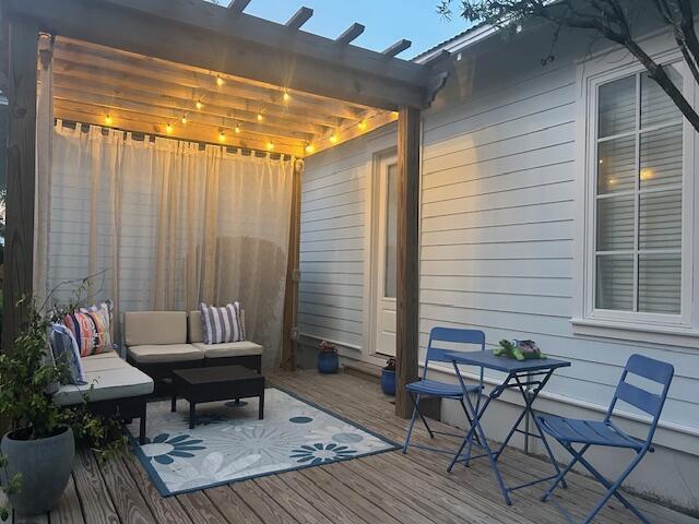 384 Carson Oaks Ln, Santa Rosa Beach, FL 32459 - wooden deck featuring an outdoor living space and a pergola