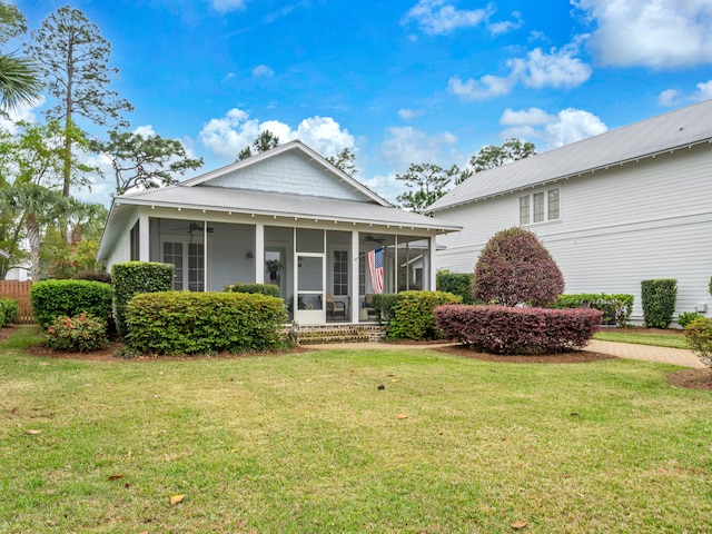 384 Carson Oaks Ln, Santa Rosa Beach, FL 32459 - view of front of house with a ceiling fan, a sunroom, and a front yard