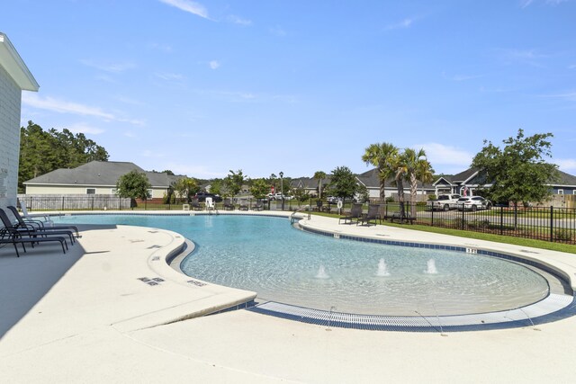 448 Whispering Creek Ave, Freeport, FL 32439 - community pool featuring a patio area and a residential view