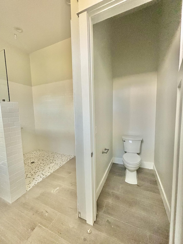 LOT11 E Georgie Pt, Washington, FL 32459 - bathroom featuring toilet, wood finished floors, tiled shower, and baseboards