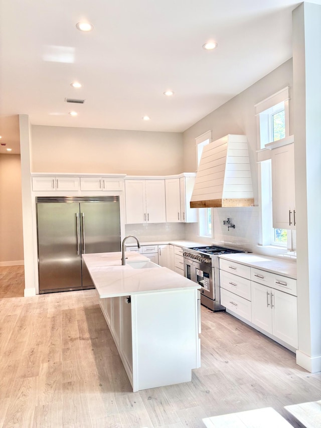 LOT11 E Georgie Pt, Washington, FL 32459 - kitchen featuring high quality appliances, custom range hood, a sink, white cabinetry, and recessed lighting