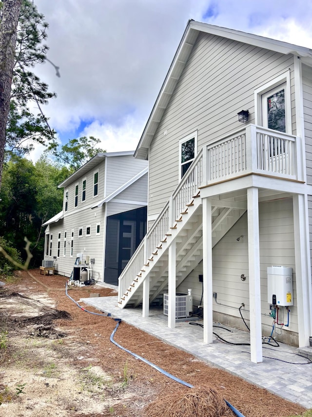 LOT11 E Georgie Pt, Washington, FL 32459 - back of house featuring stairway, central AC unit, a patio area, and water heater