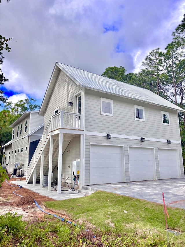 LOT11 E Georgie Pt, Washington, FL 32459 - view of side of property featuring a garage, driveway, metal roof, and stairway