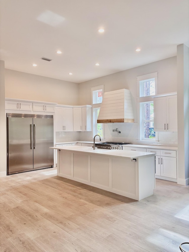 LOT11 E Georgie Pt, Washington, FL 32459 - kitchen with built in refrigerator, a center island with sink, premium range hood, white cabinets, and light countertops