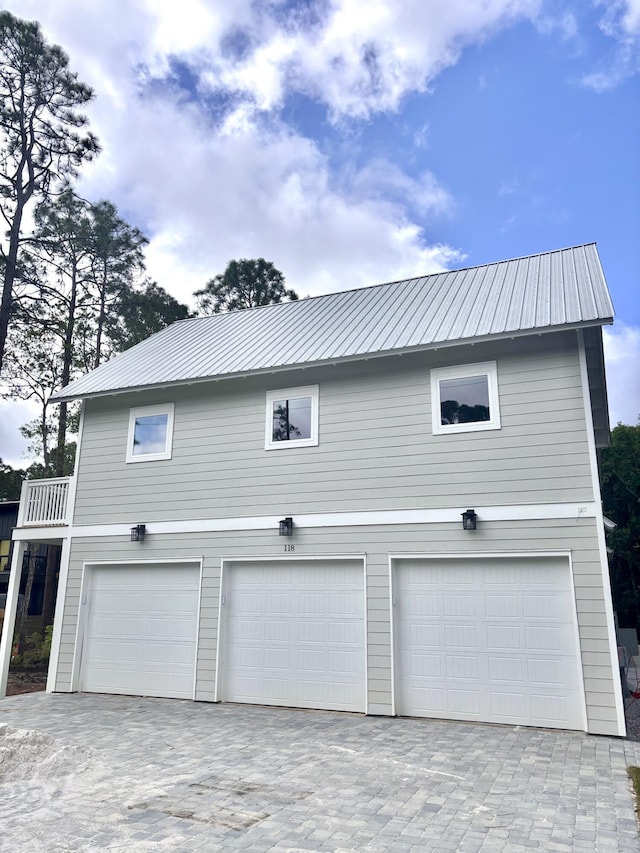 LOT11 E Georgie Pt, Washington, FL 32459 - view of side of home featuring metal roof, an attached garage, and decorative driveway