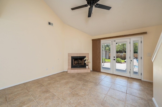 unfurnished living room with french doors, baseboards, visible vents, a tiled fireplace, and a ceiling fan