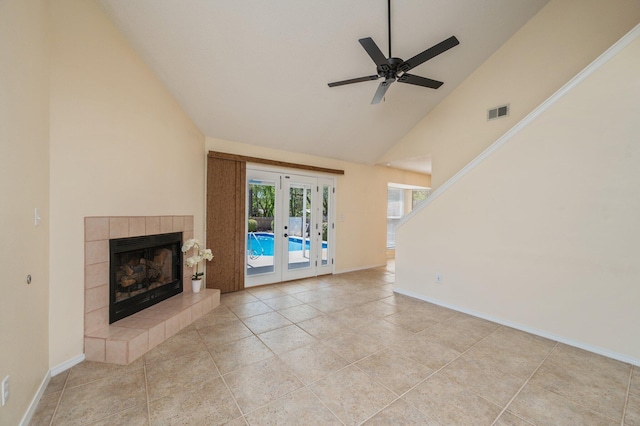 unfurnished living room with baseboards, visible vents, a tile fireplace, and french doors