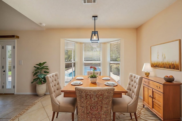 dining room with baseboards, visible vents, and light tile patterned floors