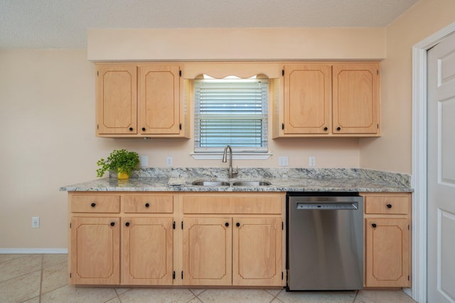 kitchen featuring dishwasher, a sink, light brown cabinetry, and light stone countertops