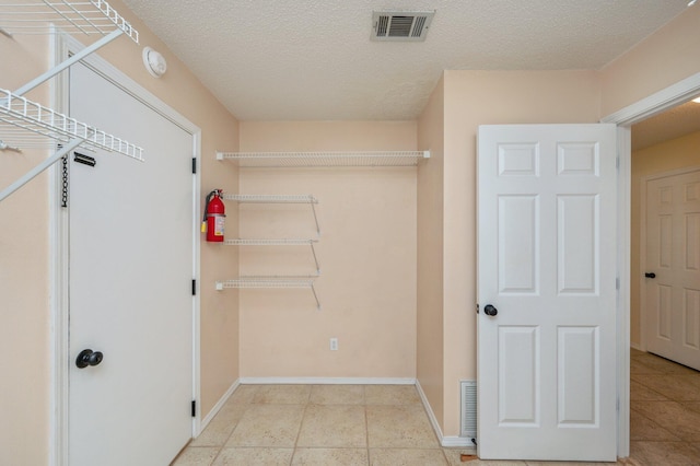 spacious closet with visible vents and tile patterned flooring