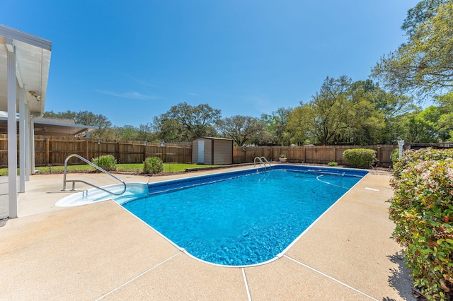 view of pool with a fenced backyard, a fenced in pool, a shed, and a patio