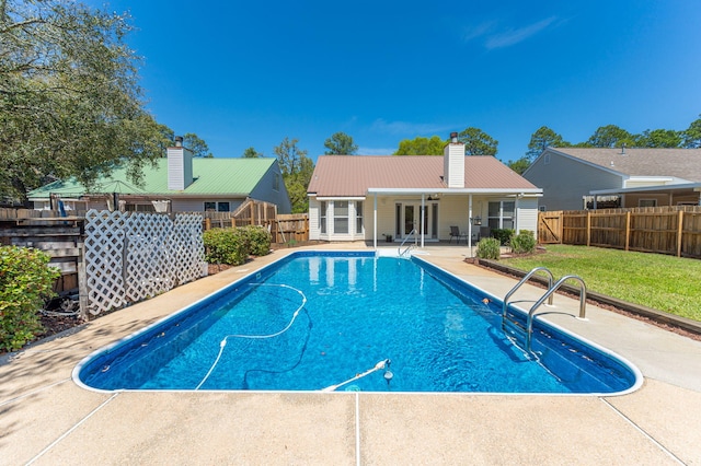 view of pool featuring a fenced backyard, a lawn, a patio, and a fenced in pool
