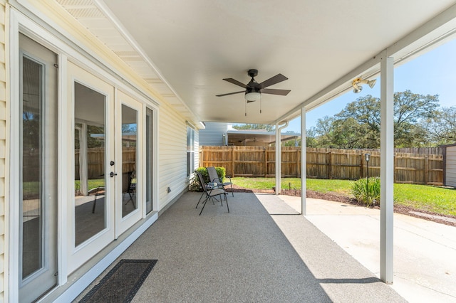 view of patio featuring fence, french doors, and a ceiling fan