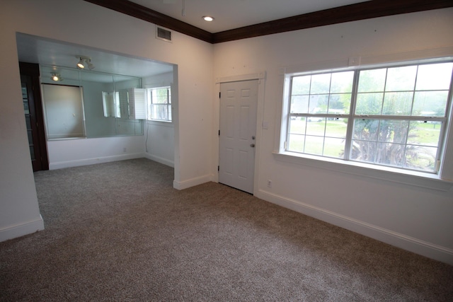 carpeted empty room with baseboards, visible vents, crown molding, and recessed lighting
