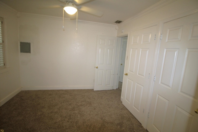 unfurnished bedroom with carpet floors, crown molding, baseboards, and visible vents