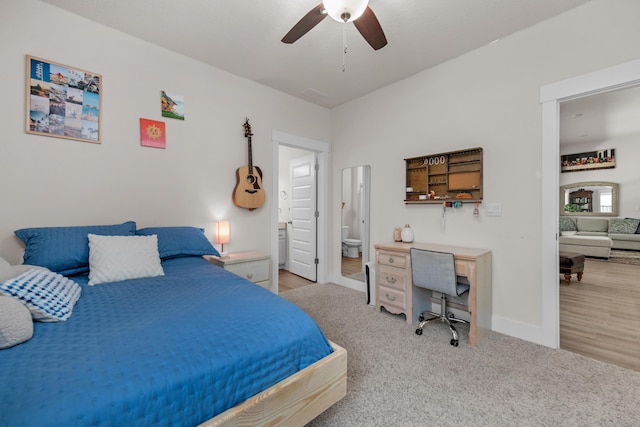 carpeted bedroom with ensuite bath, baseboards, ceiling fan, and visible vents