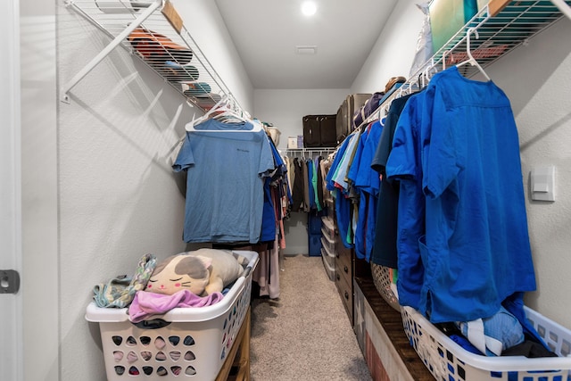 walk in closet featuring carpet