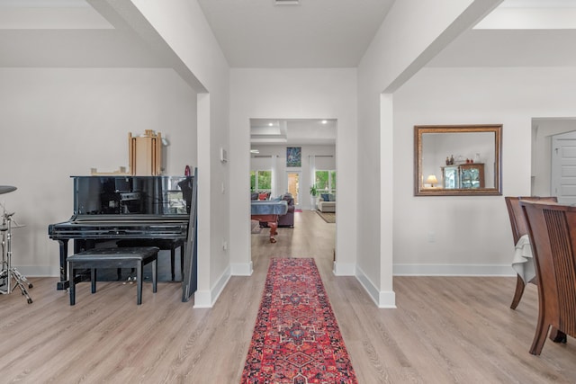 foyer entrance with baseboards and light wood-type flooring