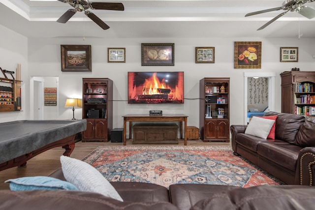 living area featuring wood finished floors, a ceiling fan, and billiards