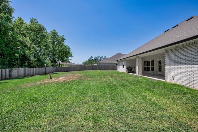view of yard with a fenced backyard and a patio