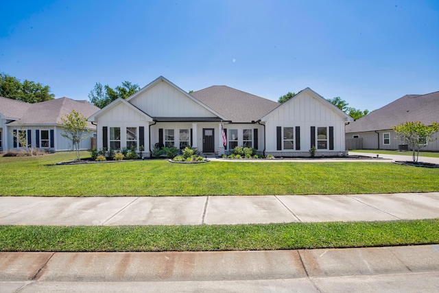 modern farmhouse featuring board and batten siding and a front yard
