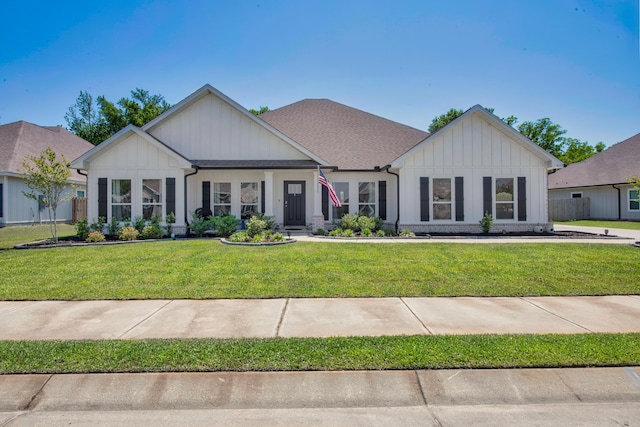 view of front of house featuring board and batten siding and a front yard